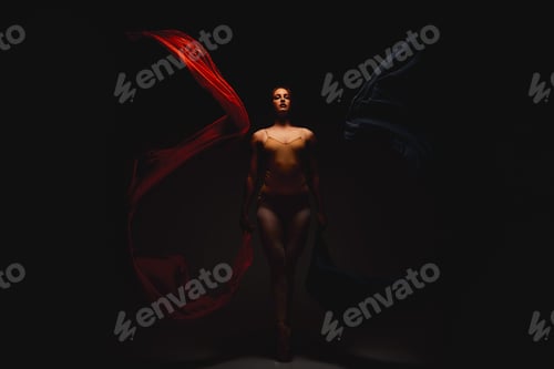 Preview: She emanates magic. Shot of a performer dancing against a dark background.