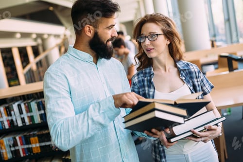 Preview: Young attractive students spending time in library
