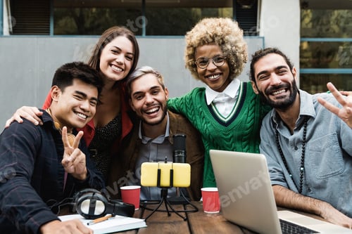 Preview: Multiracial people streaming live podcast online using microphone and laptop computer outdoor