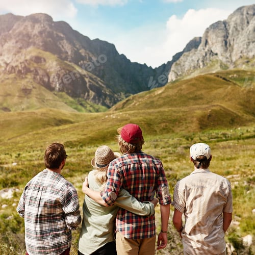 Preview: Rearview shot of a young couple admiring a mountainous view in nature