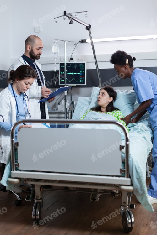 Preview: Team of medics presenting treatment options to patient with lung illness while recieving care