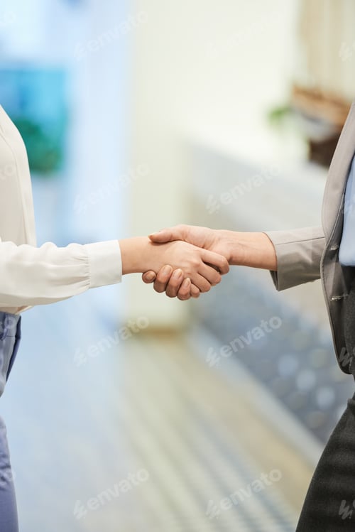 Preview: Businesswomen Shaking Hands in Office Corridor