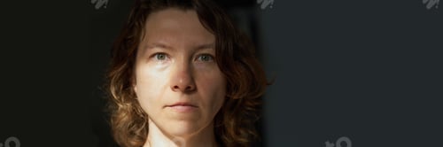 Preview: Contemplative caucasian young adult female in natural light with short wavy