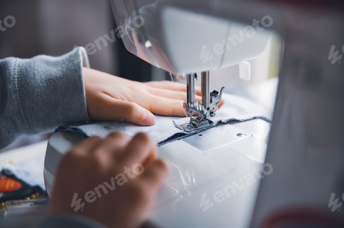 Preview: young girl working with sewing machine
