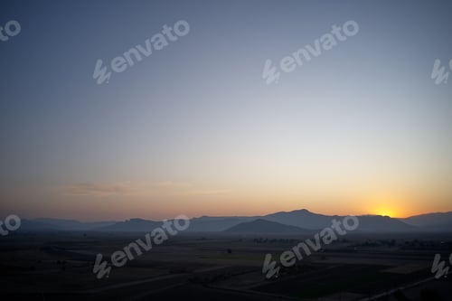 Preview: Aerial view of mountain valley at sunset.