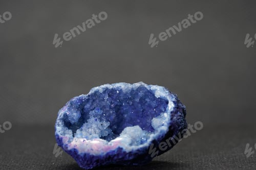 Preview: Closeup of a beautiful blue agate stone on a gray surface