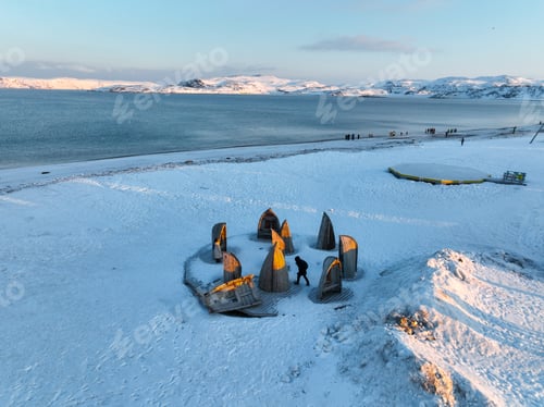 Preview: Snow-covered beach with wooden structures in Teriberka