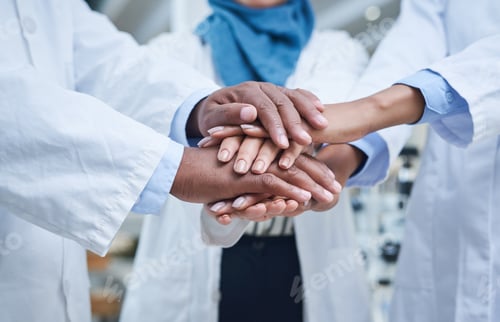 Preview: Shot of a group of unrecognisable scientists joining hands in solidarity in a laboratory