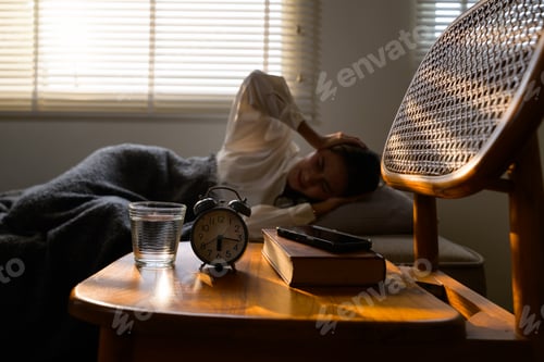 Preview: Woman suffering from headache after waking up late in morning