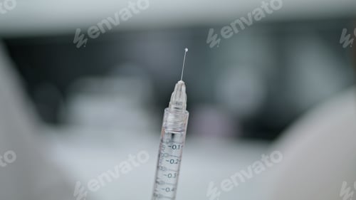 Preview: Medical syringe filled medicines closeup. Clinic worker preparing drug injection