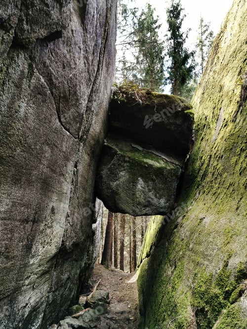 Preview: Vertical shot of rock stuck between two cliffs in Larvik, Norway