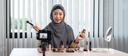 Preview: Woman Muslim blogger is showing present make up tutorial beauty cosmetic review product and live