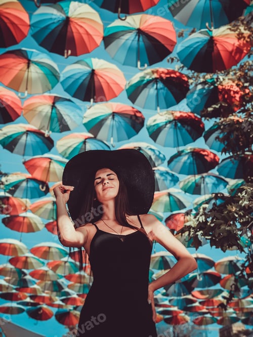 Preview: Portrait of a girl in black under colorful umbrellas
