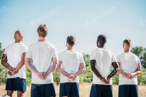 Preview: back view of multiracial soldiers standing on range on summer day