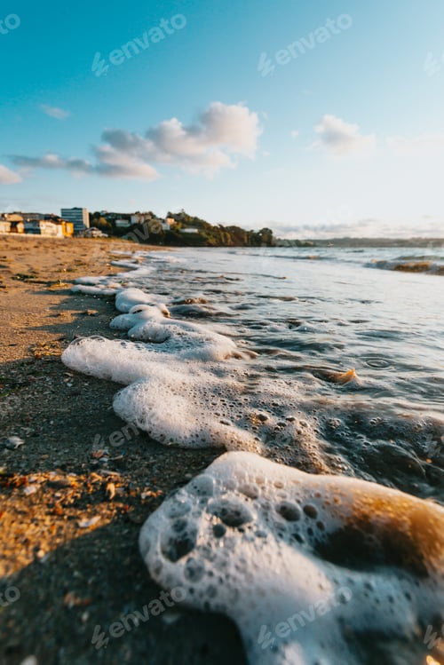 Preview: Some tides with bubbles in the beach at the city during a super colorful sunshine, summer concept