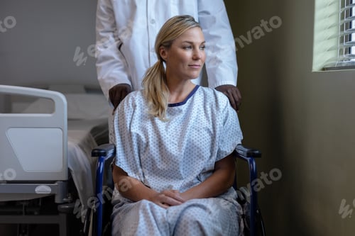 Preview: Portrait of caucasian female patient sitting on wheelchair looking through the window