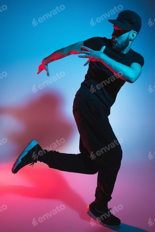 Preview: The silhouette of one hip hop male break dancer dancing on colorful background