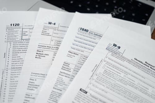 Preview: Various tax forms placed on laptop serve for specific purpose in tax system helping individuals