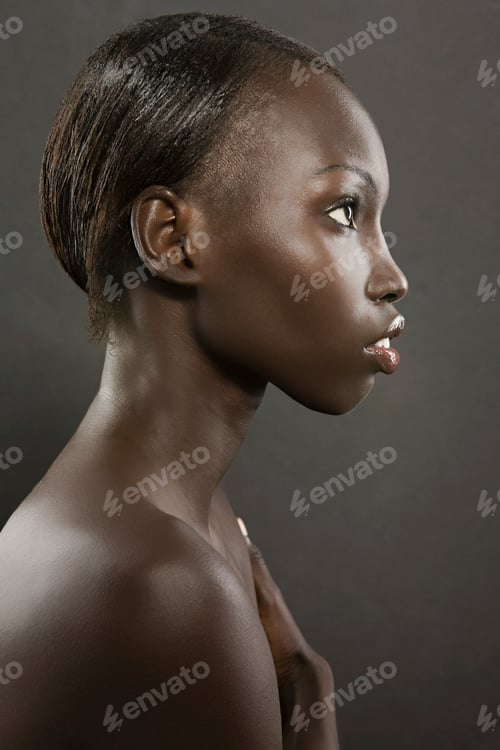 Preview: Serene profile portrait of a young person against a dark backdrop