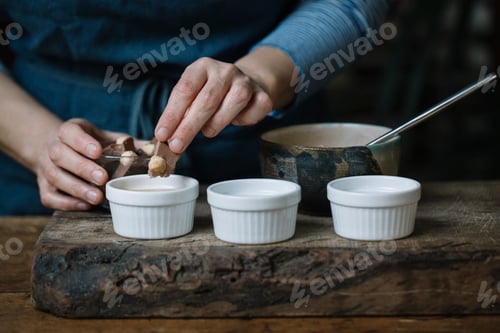 Preview: Woman preparing dessert, partial view