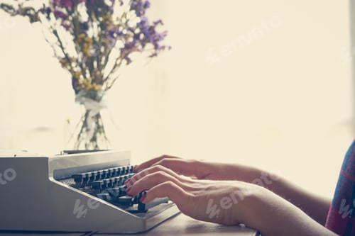 Preview: Girls hands typing in vintage typewriter