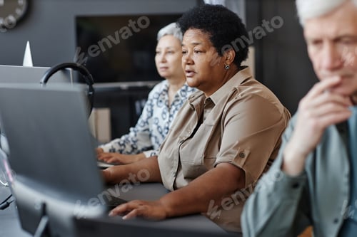Preview: Mature black woman using computer in programming class for seniors