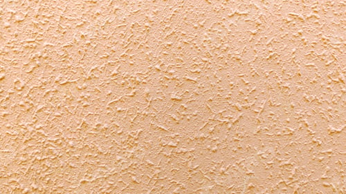 Preview: Close Up Background of Beige Stucco Wall Texture with Rough Plaster Surface for Interior design