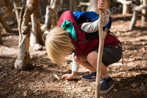 Preview: Little girl with stick touching ground