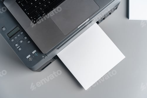 Preview: Printer and laptop on grey table in office