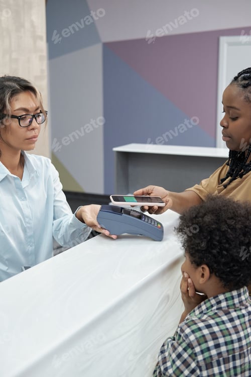 Preview: Contemporary African female paying for medical service