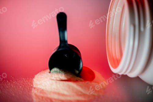 Preview: Scoop of Protein Powder on Red Surface