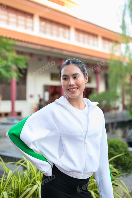Preview: Young Asian Woman in Sporty Casual Outfit Outdoors in Zen Garden
