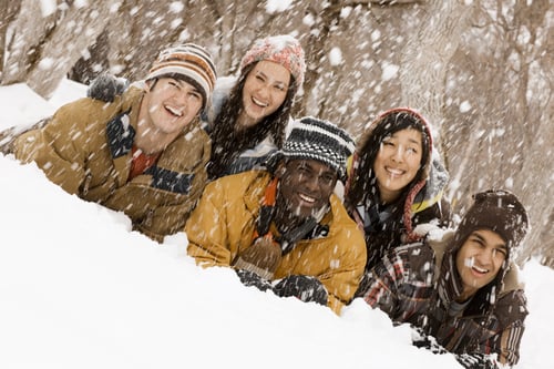 Preview: Five young people lying on the snow laughing. Snow falling.