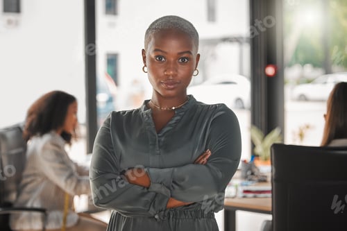 Preview: Lets get working. Shot of a young businesswoman standing with her arms crossed at work.
