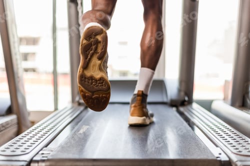 Preview: Black African American young man doing cardio workout at the gy