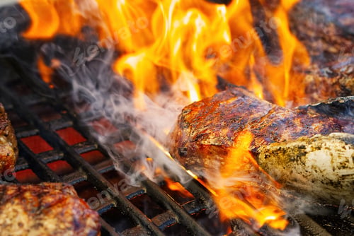 Preview: grilling steaks on gas grill and shot with selective focus