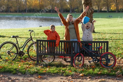Preview: Happy family celebrating bike ride in sunny autumn park lakeside