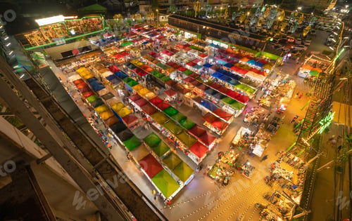 Preview: Aerial top view of Night Market people walking street, Colorful tents. Retail shops