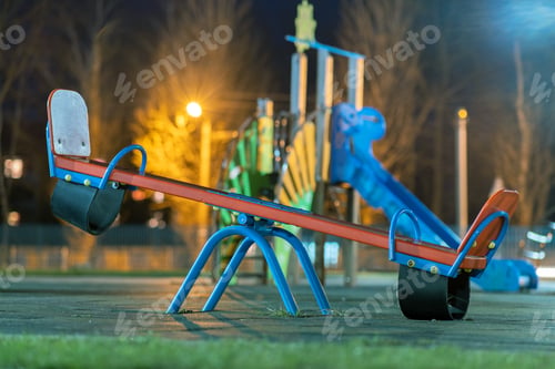 Preview: Seesaw swing in preschool yard with soft rubber flooring at night