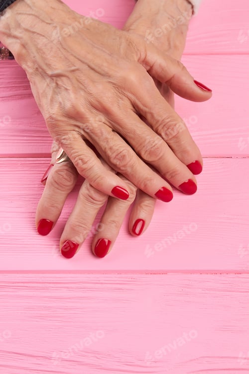 Preview: Female manicured hands on wooden background
