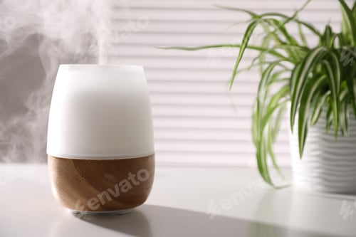 Preview: One stylish aroma lamp on white table indoors, closeup. Space for text