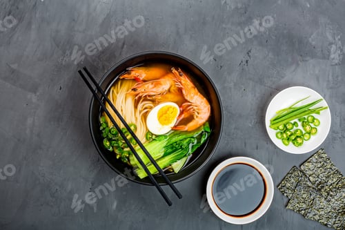 Preview: Asian noodle soup, ramen with prawn shrimp, vegetables and egg in black bowl on gray concrete