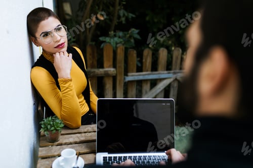Preview: Faceless man sitting in cafe with woman