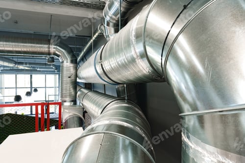 Preview: Silver ventilation pipes hanging from the ceiling inside the building