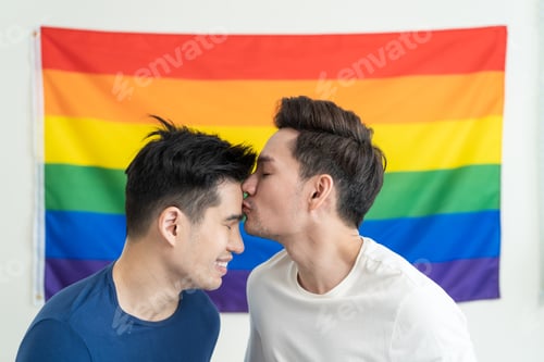 Preview: Portrait of Asian handsome man gay family holding LGBT flag and smile.