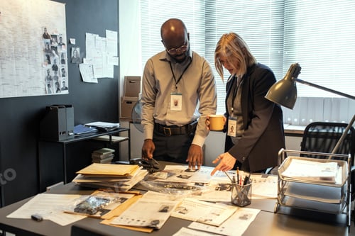 Preview: Two intercultural investigators in formalwear discussing personal information