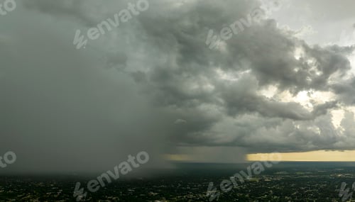 Preview: Dark stormy clouds forming on gloomy sky during heavy rainfall season over suburban town area