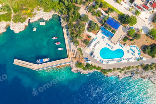 Preview: Aerial view of sea coast with clear blue water, boats and pool