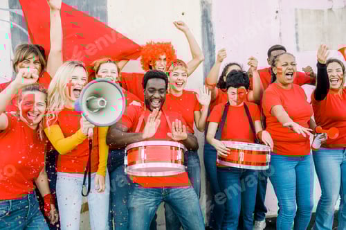 Preview: Cheering Fans Dressed in Red Raise Hands Together