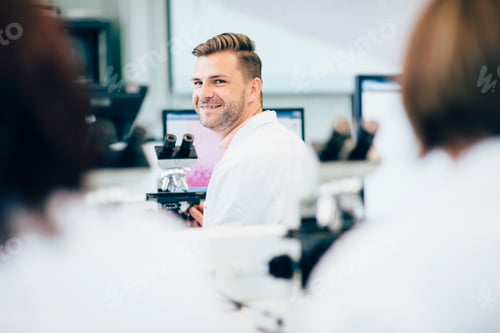 Preview: Smiling man engaging in an office conversation